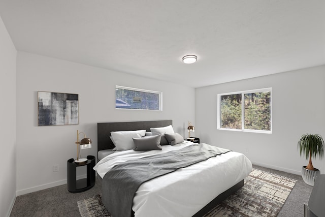 carpeted bedroom featuring baseboards