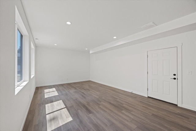 empty room with recessed lighting, baseboards, and wood finished floors