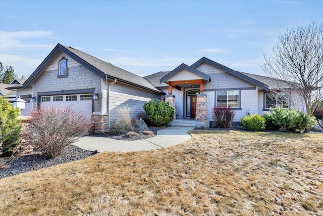 craftsman inspired home featuring stone siding, roof with shingles, and an attached garage