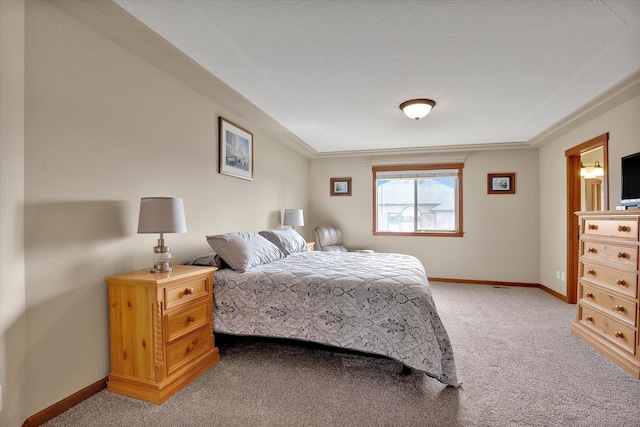 bedroom with baseboards and light colored carpet