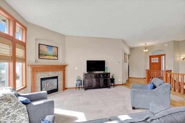 living area with light colored carpet, a healthy amount of sunlight, and baseboards