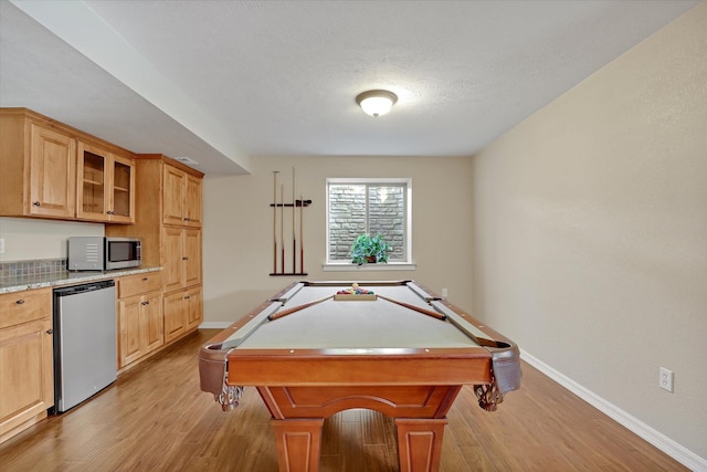 recreation room featuring pool table, baseboards, light wood finished floors, and a textured ceiling