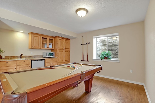 playroom featuring pool table, wood finished floors, baseboards, and a textured ceiling