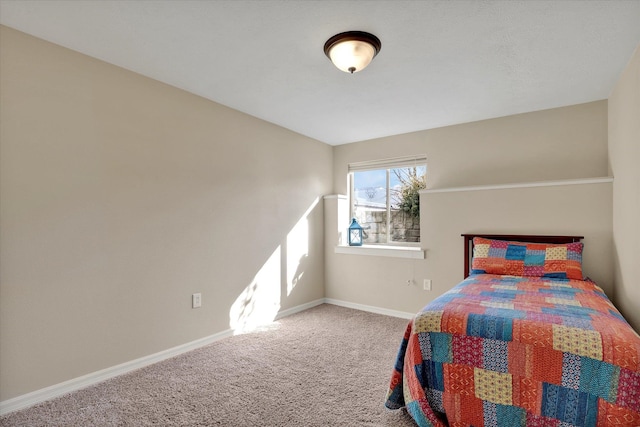 bedroom featuring baseboards and carpet floors