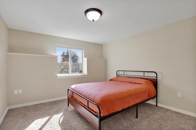 bedroom with baseboards and carpet