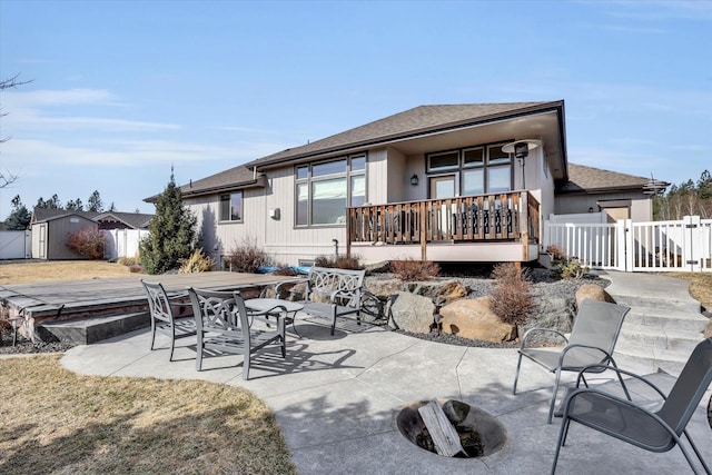 rear view of house with a patio, a gate, fence, a shed, and an outdoor structure