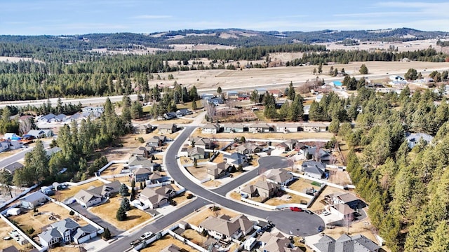 birds eye view of property with a wooded view and a residential view