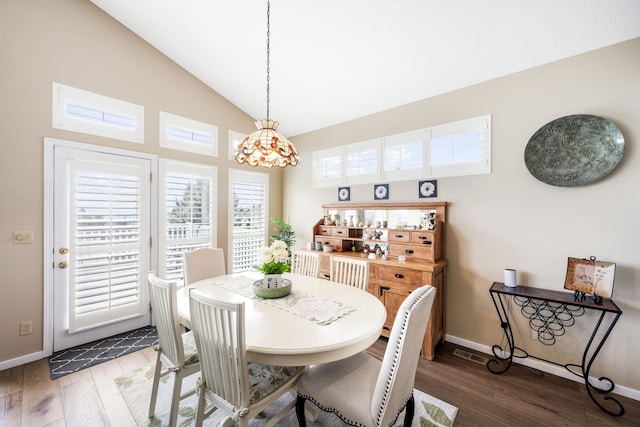 dining area with lofted ceiling, baseboards, and wood-type flooring