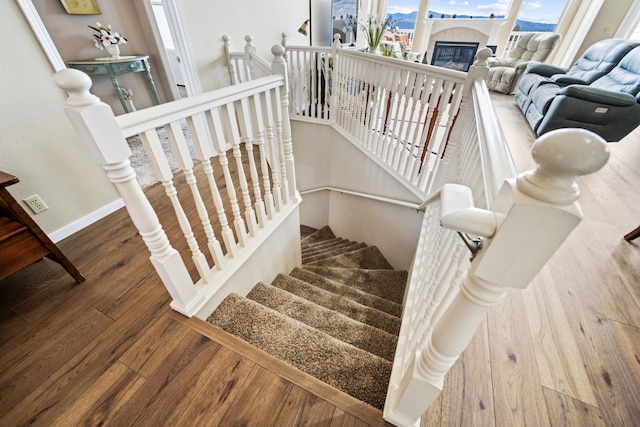 stairway featuring baseboards and wood finished floors