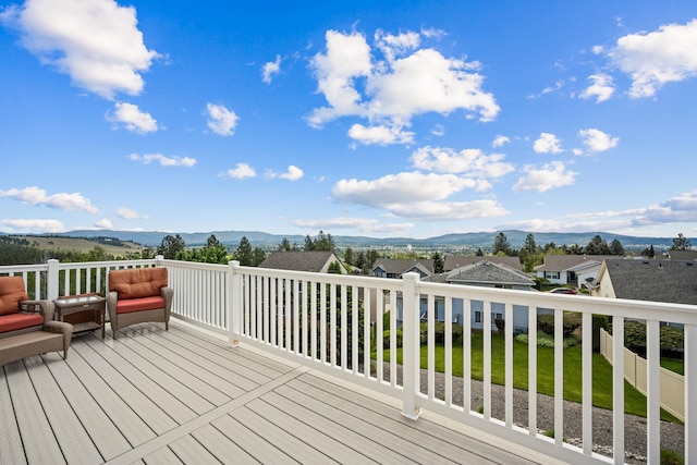 deck featuring a mountain view and a residential view