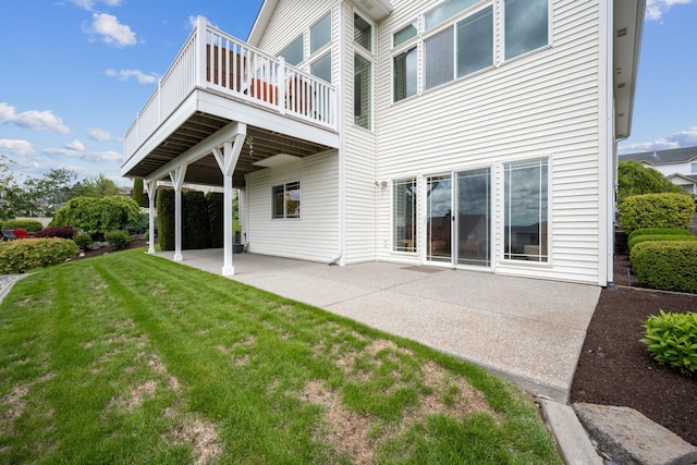 back of property with a yard and a patio area