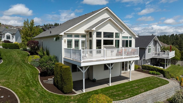 rear view of house featuring a yard and a patio area