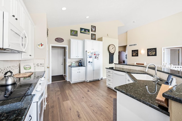 kitchen featuring light wood-style flooring, white appliances, white cabinetry, and a sink