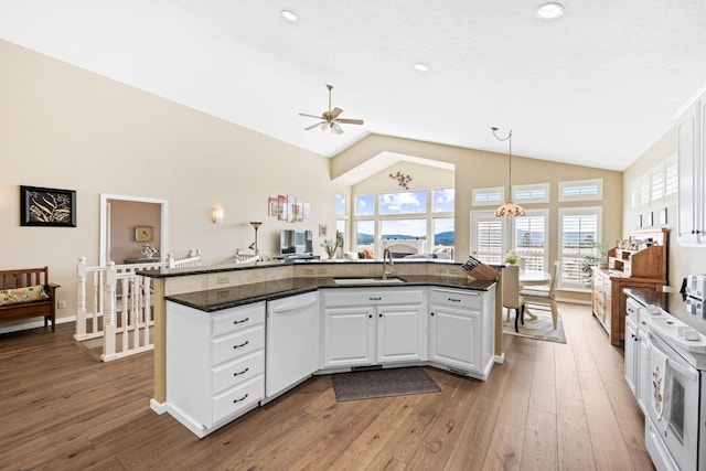 kitchen with white appliances, dark wood-type flooring, white cabinets, pendant lighting, and ceiling fan with notable chandelier