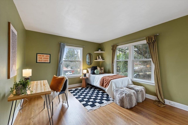 bedroom featuring baseboards and wood finished floors