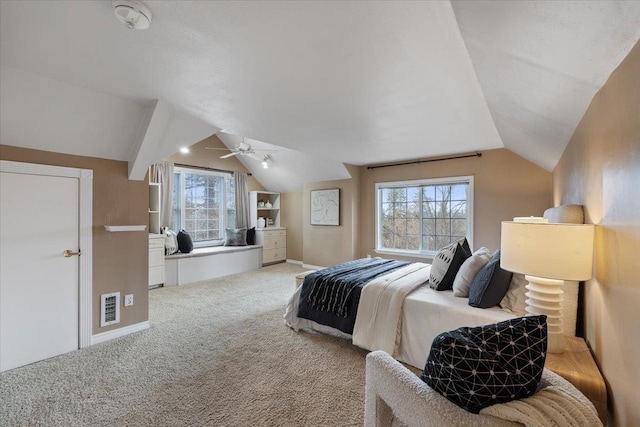 carpeted bedroom with visible vents, baseboards, and vaulted ceiling