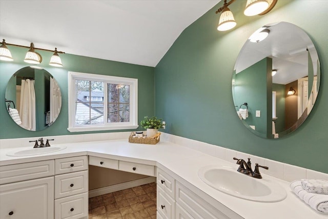 bathroom with vanity and lofted ceiling