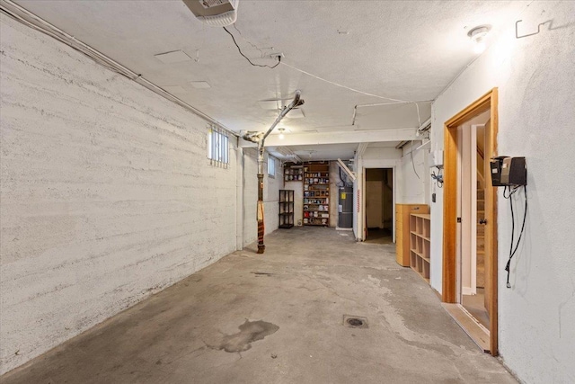 unfinished basement with electric water heater