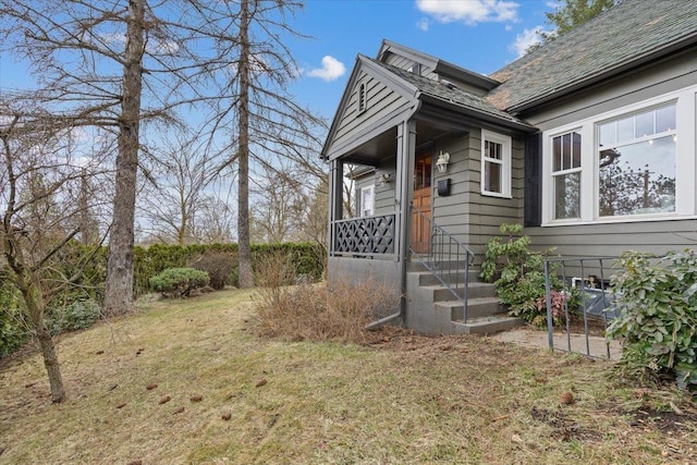 view of side of home featuring a lawn