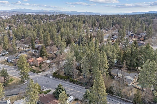 aerial view featuring a view of trees and a mountain view