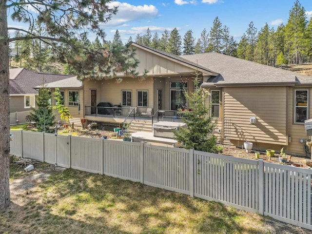 rear view of house with a fenced backyard and a patio area