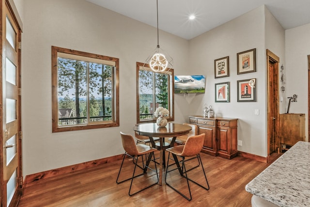 dining room with recessed lighting, baseboards, and wood finished floors