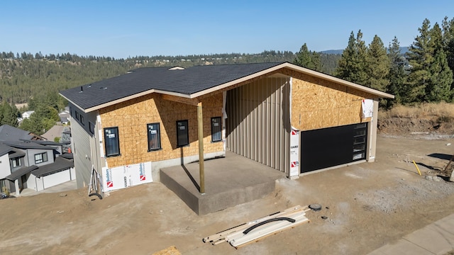 5227 S Lincoln Way, Spokane, WA 99224 - unfinished property with a forest view and a detached garage