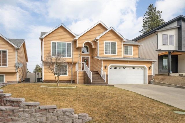 raised ranch with a garage, a front yard, cooling unit, and driveway