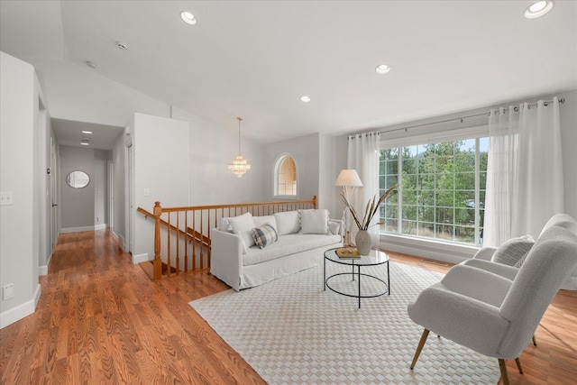 living area featuring vaulted ceiling, recessed lighting, and wood finished floors