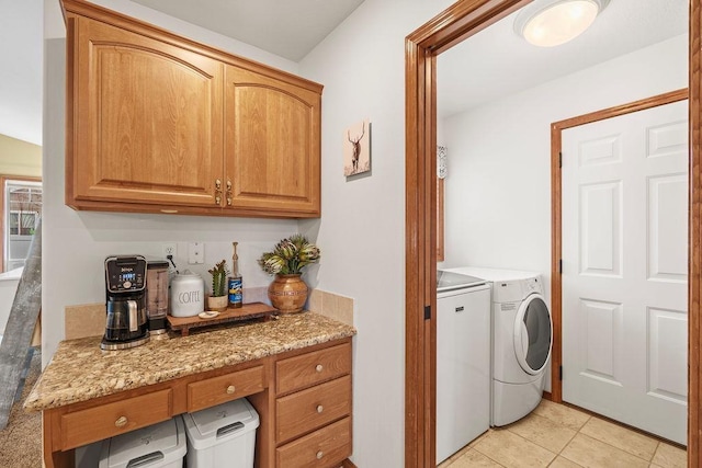 laundry area with laundry area, light tile patterned flooring, and washing machine and dryer