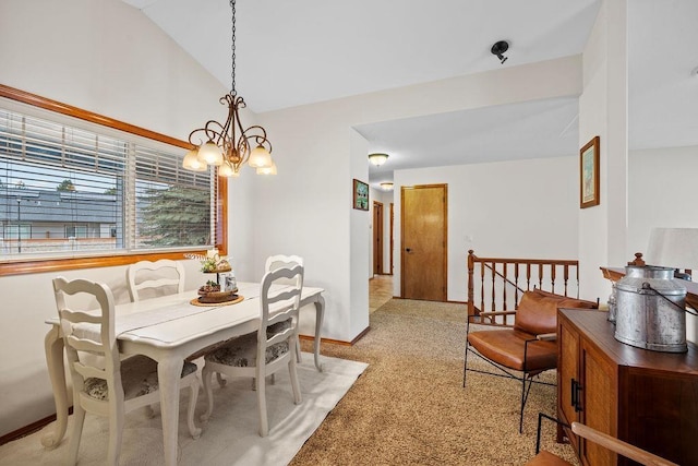 dining area with lofted ceiling and a notable chandelier