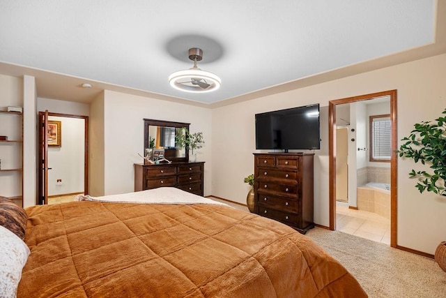 bedroom featuring light tile patterned floors, baseboards, light carpet, and connected bathroom