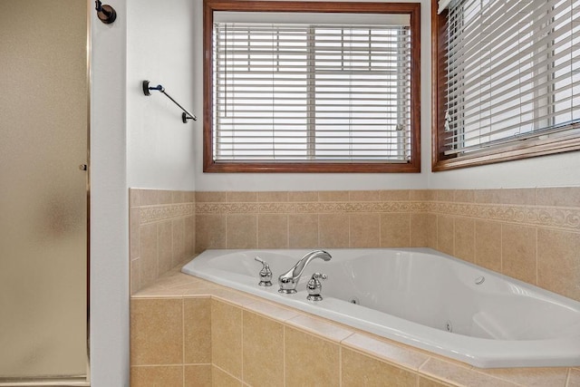 bathroom featuring a tub with jets