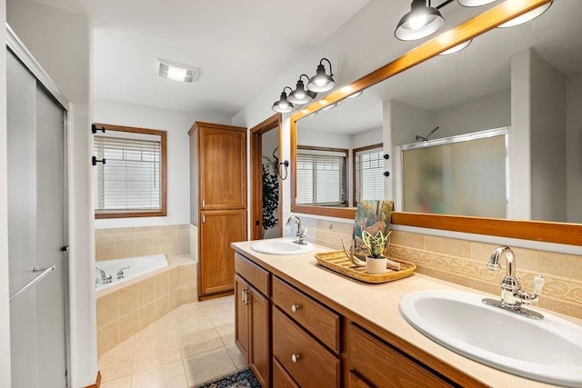 full bathroom featuring tile patterned flooring, a shower stall, double vanity, and a sink