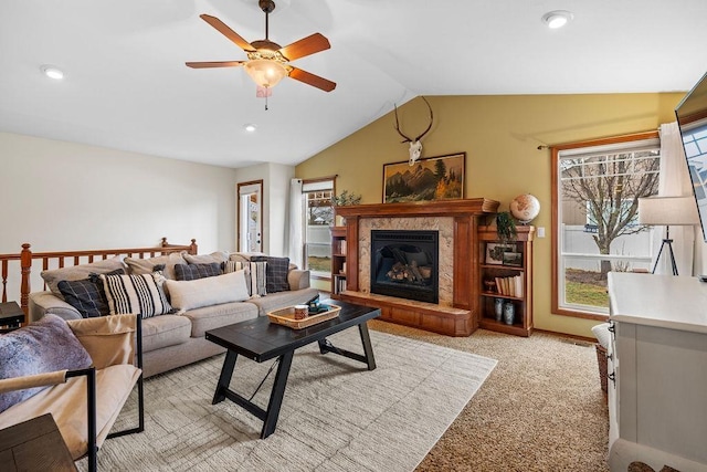 living room featuring ceiling fan, lofted ceiling, light carpet, recessed lighting, and a glass covered fireplace