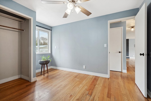 bedroom with baseboards, light wood-style flooring, and a ceiling fan