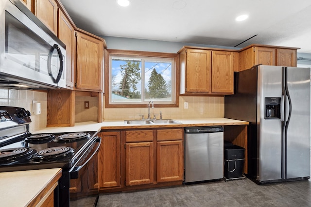 kitchen with a sink, light countertops, decorative backsplash, and stainless steel appliances