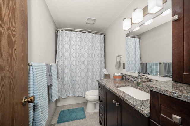 bathroom featuring tile patterned floors, toilet, and vanity