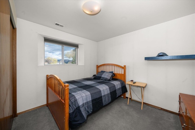 carpeted bedroom featuring baseboards and visible vents