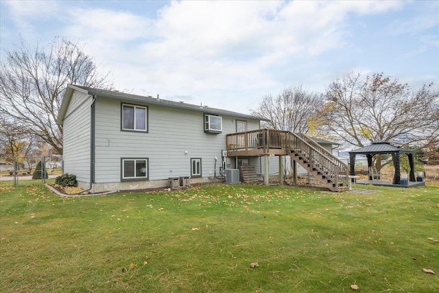 back of property featuring central air condition unit, a deck, a gazebo, stairway, and a yard