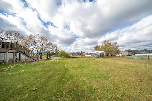 view of yard featuring a gazebo, stairway, and fence