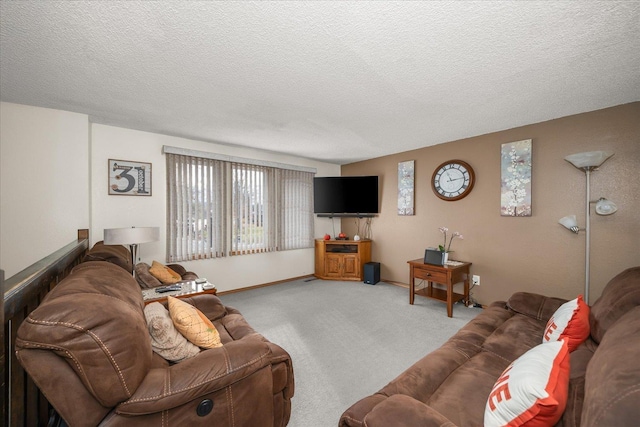 living room with carpet, baseboards, and a textured ceiling