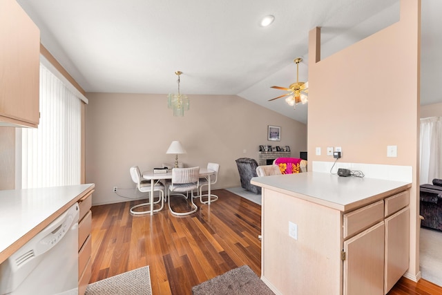 kitchen with wood finished floors, white dishwasher, ceiling fan, vaulted ceiling, and light countertops