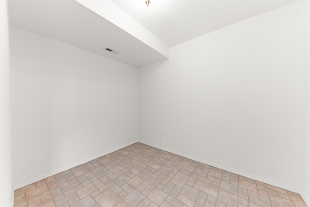 empty room with visible vents and baseboards