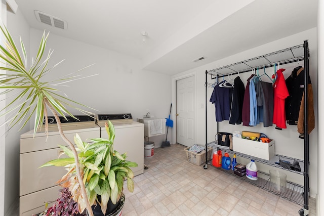 laundry room featuring a sink, laundry area, visible vents, and washing machine and clothes dryer