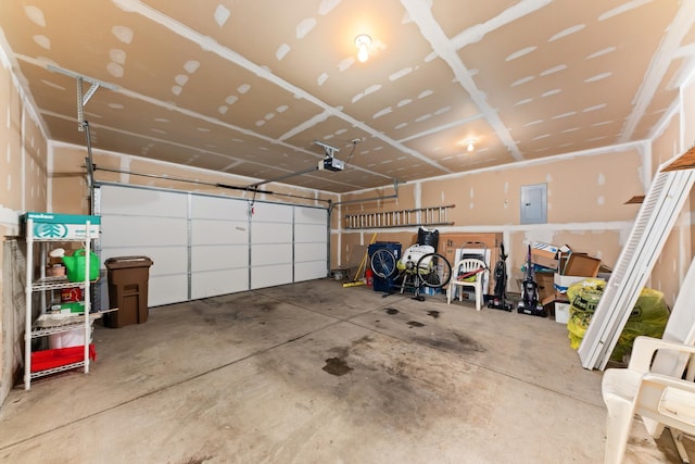 garage with electric panel and a garage door opener