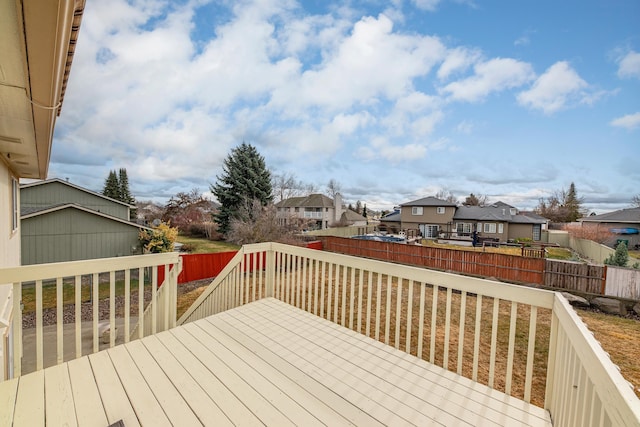 wooden terrace featuring a fenced backyard and a residential view