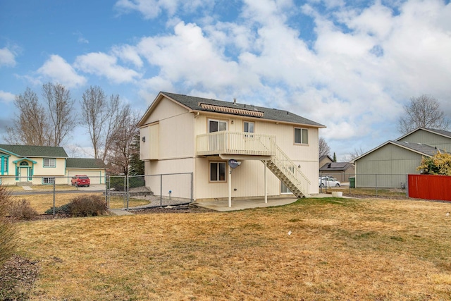 back of property with a gate, fence, solar panels, a patio area, and a lawn