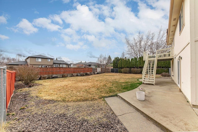 view of yard with stairway, a patio, and a fenced backyard