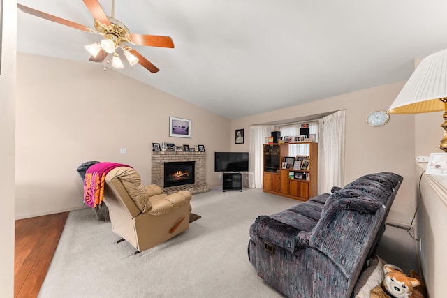 living room featuring washer and clothes dryer, a fireplace, a ceiling fan, and lofted ceiling